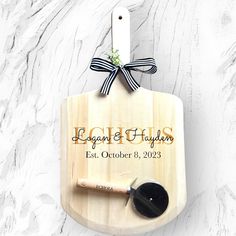 a personalized cutting board with a spoon on it and a bow around the handle