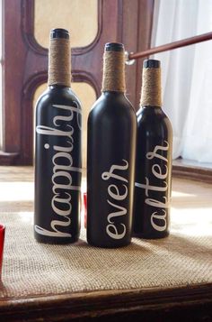 three black bottles sitting on top of a table