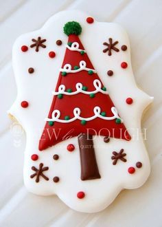 a cookie decorated like a christmas tree on top of a table