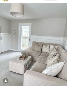 a living room filled with furniture and a flat screen tv on top of a wall