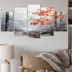 a living room scene with a couch and paintings on the wall in front of it