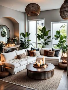 a living room filled with lots of furniture next to tall windows and plants on the wall