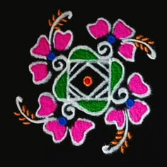 an embroidered design with flowers and leaves on black background, in the shape of a flower