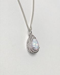 Sterling Silver White Fire Opal Necklace Metal: All Components Are Made From Solid .925 Sterling Silver Stone: Lab created Opal and CZ Measurement: pendant height is 15mm Choose Chain Length At Checkout Please feel free to Convo me with any questions before purchasing. Please view policy before purchasing Other Opal Necklaces can be found here https://www.etsy.com/shop/LinksAndStones?ref=ss_profile&section_id=24284450 Thank You For Visiting My Shop Formal Hallmarked Teardrop Necklace, Pear-shaped Sparkling Stone Necklaces For Gifts, Pear-shaped Necklaces With Sparkling Stones As Gift, Formal Sterling Silver Necklaces With Stone Setting, Formal Sterling Silver Necklace With Stone Setting, Silver Teardrop Jewelry With Stone Setting, Sterling Silver Pear-shaped Jewelry With Sparkling Stones, Elegant Teardrop Stone Setting Jewelry, Classic Teardrop Crystal Necklace