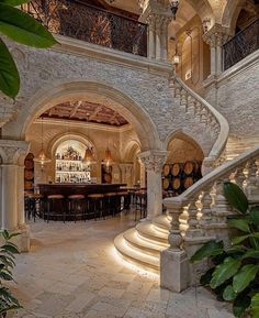 an indoor bar and wine cellar in the middle of a stone building with stairs leading up to it