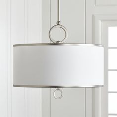 a white lamp hanging from a ceiling in a room