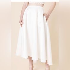 - Length 32" / Waist 28" - Measured From A Size S. - 100% Polyester - Hand Wash Cold Water; Lay Flat To Dry. - Non-Stretch - Models Are Approximately 5’10” And Wear A Size Small You'll Feel Romantic And Effortlessly Stylish In This Side Pocket Wedding Skirt. This High-Low Skirt Looks Amazing With A Lace Tank Top As The Perfect Bridal Outfit For Your Special Events. Summer Wedding A-line Skirt, Spring Wedding A-line Skirt, A-line Bottoms For Wedding, Summer Wedding Skirt Bottoms, Summer Wedding Full Skirt Bottoms, White Flowy A-line Skirt, White A-line Flowy Skirt, Wedding Flared Maxi Skirt With Lining, Spring Wedding A-line Maxi Skirt