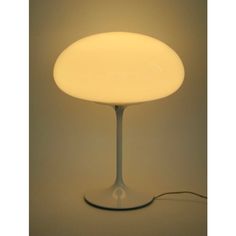 a white table lamp sitting on top of a floor