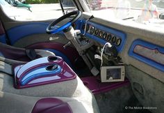 the interior of a car with purple and blue trim