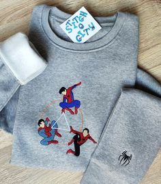 a gray sweatshirt with spider man on it