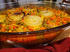 a large bowl filled with vegetables on top of a table