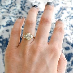 a woman's hand with a diamond ring on it