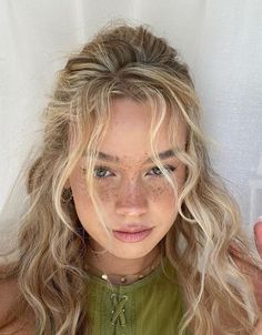 a woman with freckles on her face posing for the camera