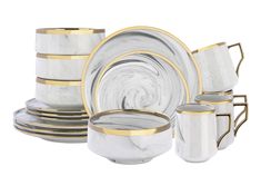 a set of white and gold dinnerware on a white background with golden rims