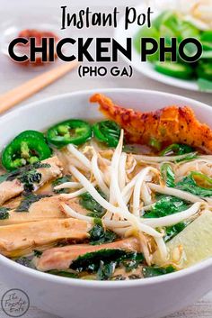 chicken pho ga in a white bowl with chopsticks on the side and green vegetables