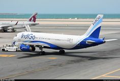 two airplanes are parked on the tarmac at an airport near the water and sand