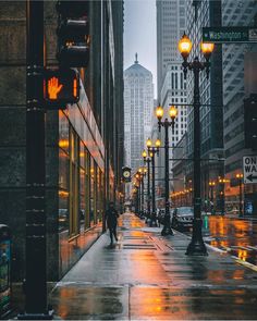 a person walking down a street in the rain