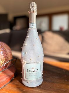 a bottle of champagne sitting on top of a wooden table