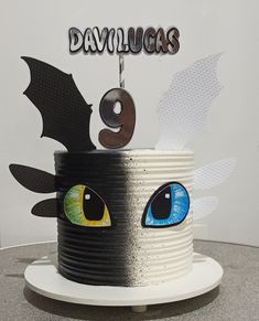 a birthday cake with an eyeball and bat decoration on it's top that says davlucks