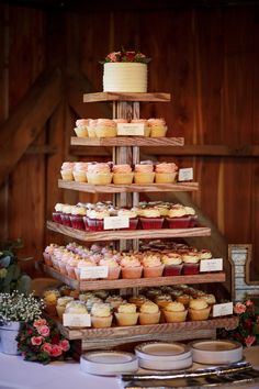 a cake and cupcakes are stacked on top of each other at a wedding