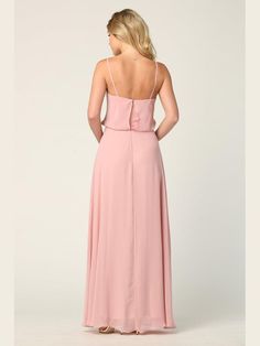 a woman in a long pink dress is looking back at the camera and she has her hands on her hips