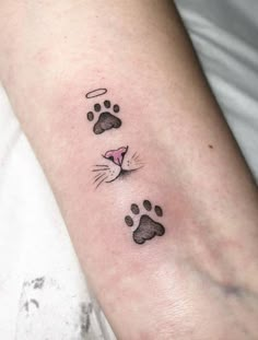 a cat paw tattoo on the left arm