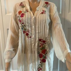 This Johnny Was Tunic Is A Trendy Must Have With A Boho-Chic Look. It Is Made Of Lightweight Ivory Fabric With Vibrant Embroidered Flowers. It Features A Relax Fit, 3/4 Sleeves, Partial Button Closure And The Hem Hits At The Hip. It Is A Perfect Top For The Summer, Fall And Spring. Ivory Fabric, Johnny Was, Embroidered Flowers, Summer Fall, Boho Chic, Tunic Tops, Relaxed Fit, Womens Tops, Cream