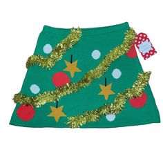 a green skirt with christmas decorations on it