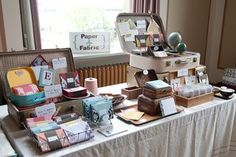 there is a table with many items on it that are sitting in front of a window