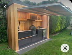 an outdoor bar with cabinets in the grass