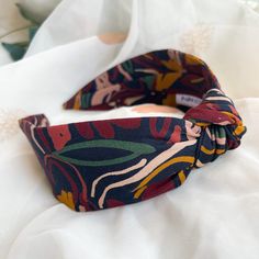 Handmade Knot Headband | Nine Designs Top knot headband in an autumnal floral print fabric. Whether its a treat for yourself or a gift for a loved one, our headbands are the perfect finishing touch to any outfit. View our full range of knot hairbands here: https://etsy.me/2LIlGCp View our satin lined headbands here: https://etsy.me/3tRGhVg - ABOUT - All our headbands are handmade, and designed for comfortable all-day wear. They are made from a super flexible base band which can be adjusted accor