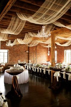 a banquet hall with tables covered in white draping