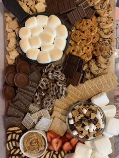 a tray filled with lots of different types of snacks and desserts on top of each other