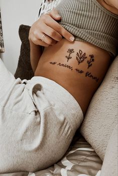 a woman with a tattoo on her stomach that says, no matter what she wants