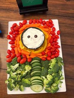 a plate topped with vegetables and a face