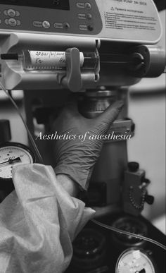 a black and white photo of someones hand holding an iv in front of a machine