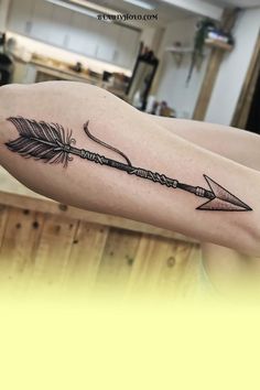 an arrow tattoo on the arm