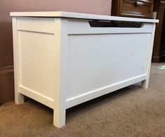 a white chest sitting on top of a carpeted floor