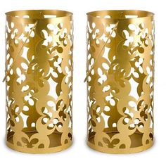 two gold vases with cut out designs on them