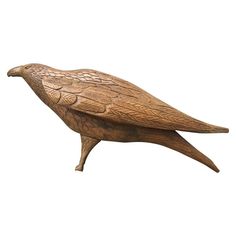 a wooden bird statue sitting on top of a white background