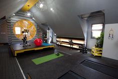 an attic gym with exercise equipment and yoga mats