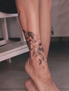 a woman's foot with flowers on it