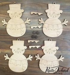 four wooden snowman ornaments are shown on a wood surface, one is cut out and the other has been made from plywood