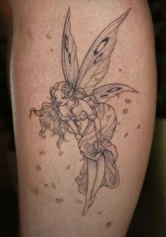 a tattoo with a fairy on it's thigh and flowers around the leg area