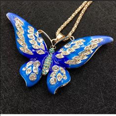 Blue Butterfly Pendant Necklace The Pendant Is Big The Color Is Blue And Golden The Butterfly’s Eyes Are Black Colored The Main Stone Is Crystal The Butterfly Has Crystals On It Long Chain Chain Length: 27.5” Pendant Size: 3.5” (Wing To Wing) Style, Chain Metal: Gold Plated Brand New Never Used Blue Butterfly Jewelry For Party, Blue Butterfly Necklace, Elegant Blue Butterfly Necklace With Charm, Elegant Butterfly Gemstone Necklace, Blue Crystal Butterfly Necklace, Gold Butterfly-shaped Crystal Jewelry, Butterfly Pendant Necklace, Big Blue, Butterfly Necklace