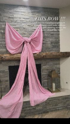 a fireplace with a pink bow on it's mantle