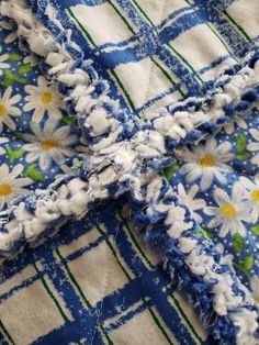 the blue and white flowered fabric has been stitched together to create a cross