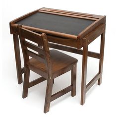 a wooden table with a black top and two chairs next to it on a white background