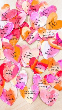 paper hearts with words written on them