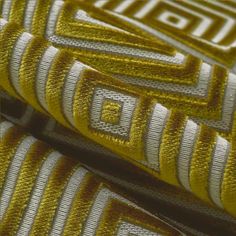 gold and white fabric with geometric designs on it